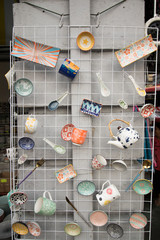 arrangement of decorative ceramic plates, tea cups and spoon in the glassware shop. 