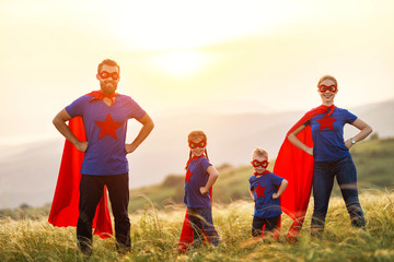 concept of super family, family of superheroes at sunset