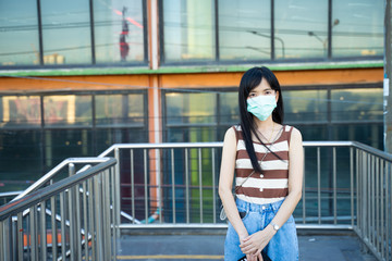 A woman wearing a mask To prevent corona virus and prevent pm 2.5 pollution in the city