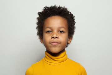 Little black kid face. Cute child boy smiling on white background