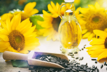 sunflower oil in glass jar with flowers of sunflower
