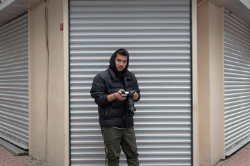 Young photographer taking photos on the streets of the city