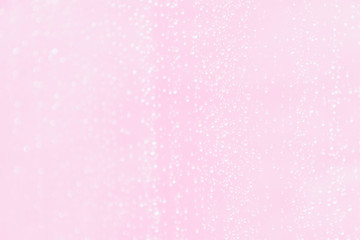 Pale pink blurred background with water drops pattern