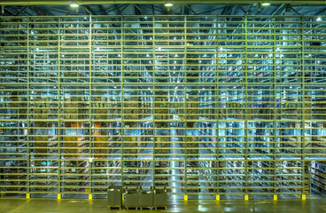 shelves and racks in a large warehouse metal mezzanine structures with goods in boxes and drawers - obrazy, fototapety, plakaty