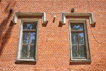 Fototapeta na wymiar The windows of the old palace with a metal mesh for security