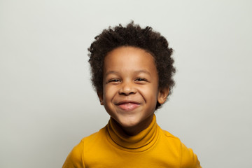 Laughing black child boy on white background