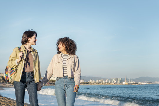 young lesbian couple walking holding hands