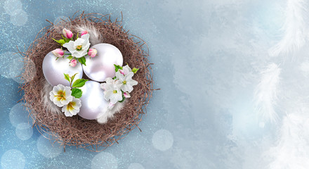 Easter festive elegant background, silver eggs in a twisted nest, feathers, branches of a blossoming white pink apple tree, the first spring flowers, place for text