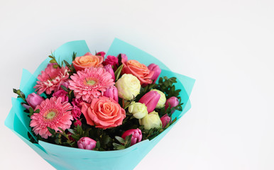 A bouquet of pink flowers, rooi tulips and herbarms for the holiday, birthday or March 8