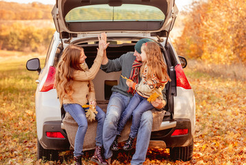 Father with daughters in autumn surroundings