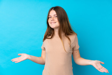 Ukrainian teenager girl over isolated blue background smiling