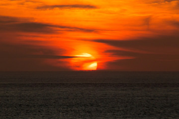 Fototapeta na wymiar The setting sun shining in the orange sinking in the sea of Japan