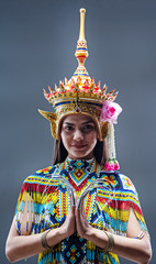 The beautiful woman wearing Thai southern folk dancing costume,made from colorful bead,put headdress on her head,press hands together at chest,practicing  and showing preformances