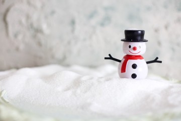Artificial snowman sending warm hugs. Copy space