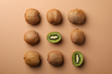 Flat lay with kiwi on craft brown background, top view