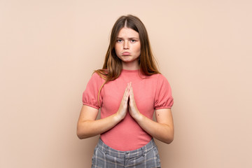 Fototapeta premium Ukrainian teenager girl over isolated background pleading