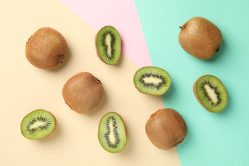 Ripe sweet kiwi on multicolor background, top view
