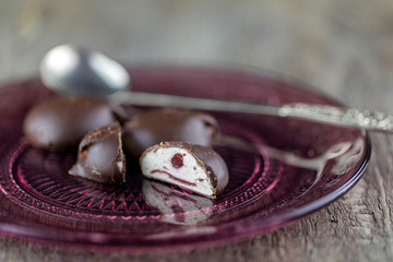Dark chocolate on a rustic wooden background. Selective focus.