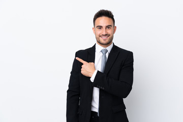 Young business man over isolated background pointing finger to the side