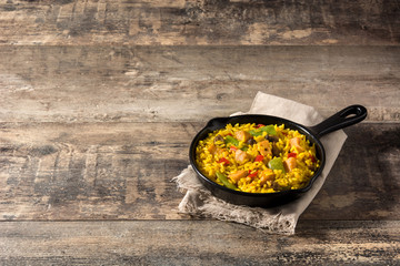 Fried rice with chicken and vegetables on frying iron pan.Copy space