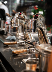 coffee filter holder ground with coffee maker machine in cafe