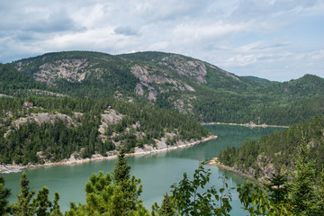 landscape photography of the Gaspé Peninsula in Quebec. Photograph of a lake with trees. Mountain with lake and trees