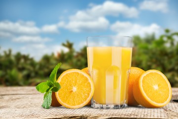 Orange juice and slices of orange on wooden desk © BillionPhotos.com