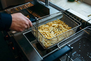 Deep fryer for potatoes in kitchen