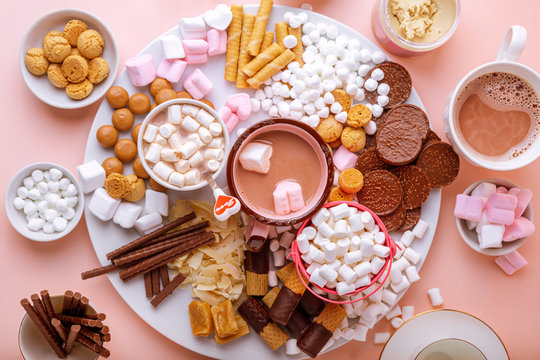 Hot chocolate, marshmallows, chocolates and cookies charcuterie board, top view