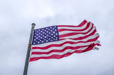 Close up view at a national USA flag moving in heavy wind