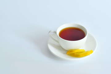 One small cup of tea with mint and lemon.