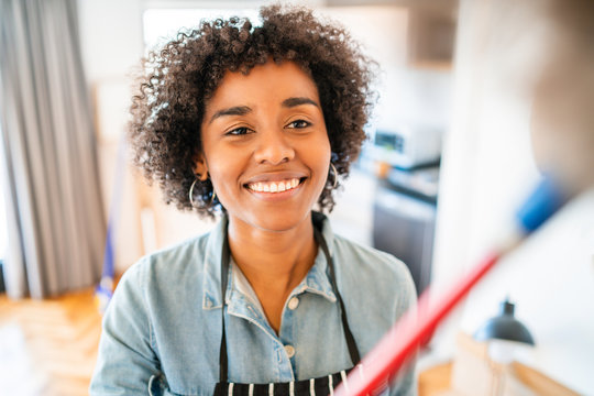 Afro Woman Dusting Her New House.