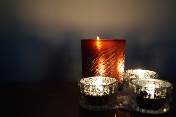 four burning candles in night romantic evening warm light macro photo