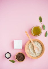 Cosmetic bath salt, grape gomaj for the face, coffee scrub for the body on a pink background.