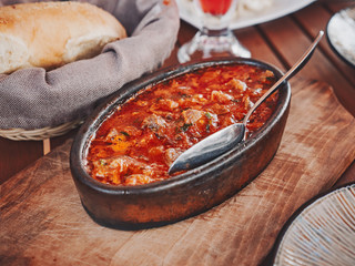 Ttraditional georgian stew chakapuli with delicious lamb meat on wooden plate