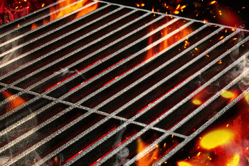 Hot empty portable summer barbecue BBQ grill with bright flaming fire and ember charcoal. Cookout concept. Close up - obrazy, fototapety, plakaty