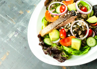 Grilled salmon fillet with vegetable salad. Fresh salad