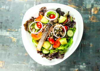 Grilled salmon fillet with vegetable salad. Fresh salad