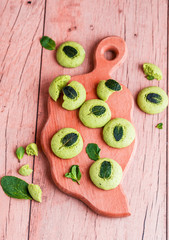 Shortbread cookies with mint, fragrant mint and sprigs of demen sedated on a wooden background. Tasty food