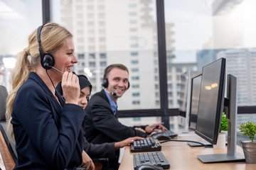 Call Center or Customer service team smiling while helping or advice customer in office