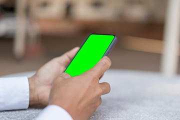 Business men are using phones with green screens