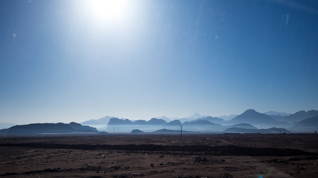 Jordan in winter, desert Uadi Rum or Wadi Rum or Valley of Moon, scenery cloudless blue sky landscape view at the end of January. Travelling in the beautiful Middle East kingdom. Sand and rocks