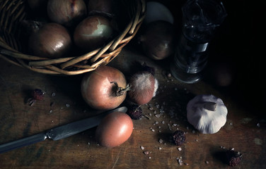 still life with onions in basket, eggs and garlic bulb