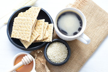 Healthy sesame biscuits (Sesamum indicum) healthy whole grain honey cereal and coffee cup