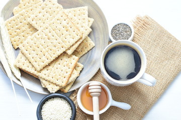 Healthy sesame biscuits (Sesamum indicum) healthy whole grain honey cereal and coffee cup