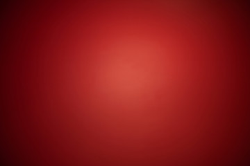 Abstract red spotlight background with dark vignettes.