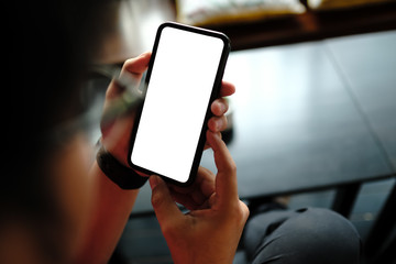 young man holding mobile smart phone with blank screen