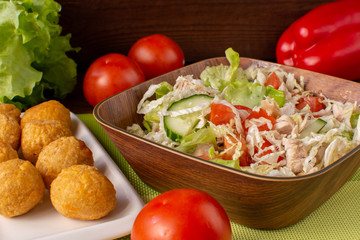 Fresh vegetable salad with nuggets. Still-life. Wooden table. Greens and vegetables.