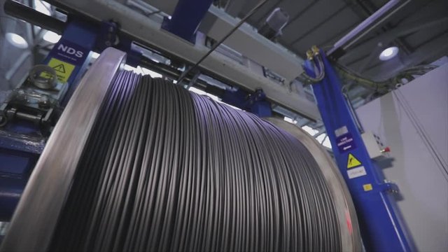 Winding of the electrical cable to the bobbin in the production. Cable pdroduction. Cable factory