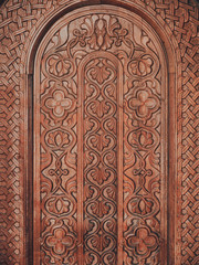 Vertical view of handmade ornate wooden gate texture